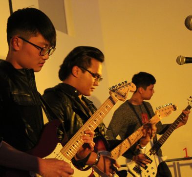 3 students rocking out with their guitars