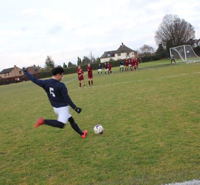 Student about to kick a football