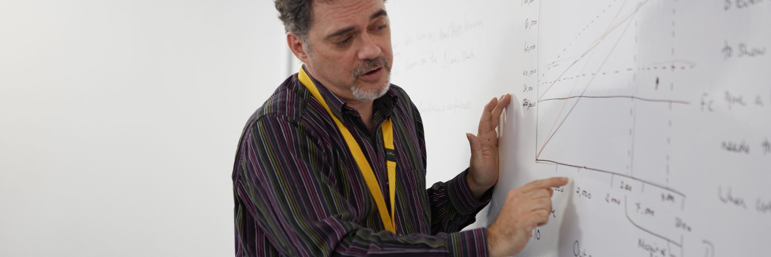 man teacher writing on a board