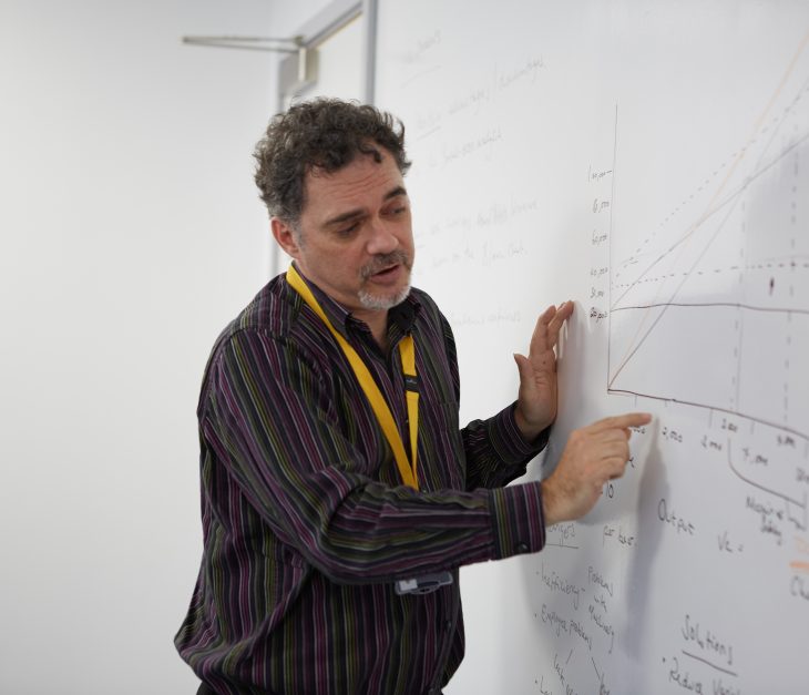 man teacher writing on a board