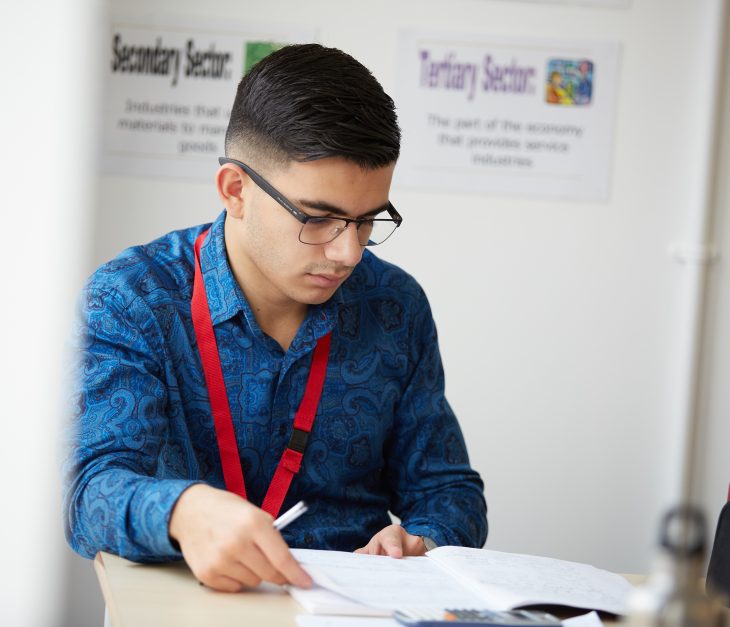 child reading his work