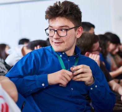 student wearing glasses and a blue shirt