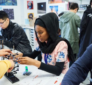 students looking at science contraption