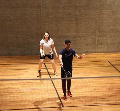 2 students playing badminton