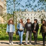 students walking with Cambridge in the background