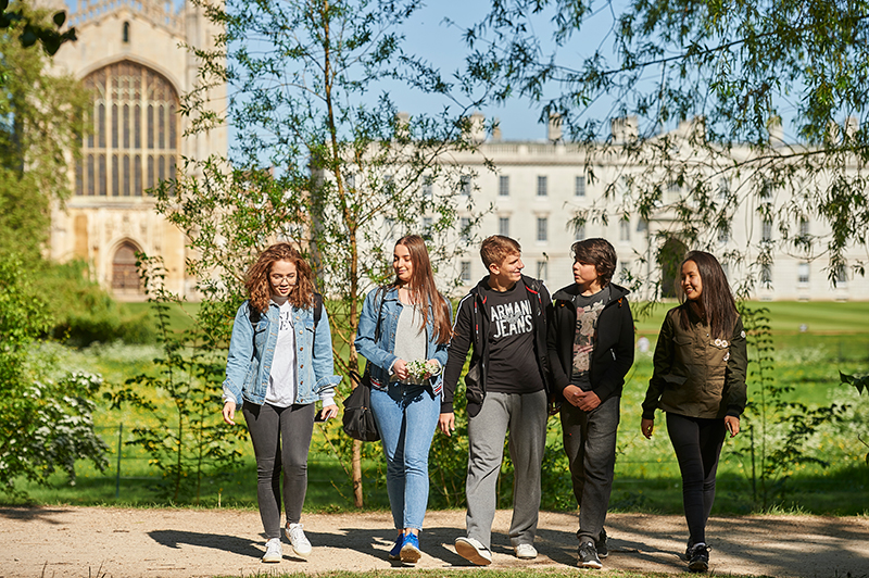 students walking with Cambridge in the background