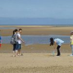 Students playing on the beach