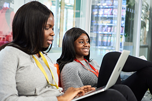 Students relaxing in the common room at Abbey College Cambridge