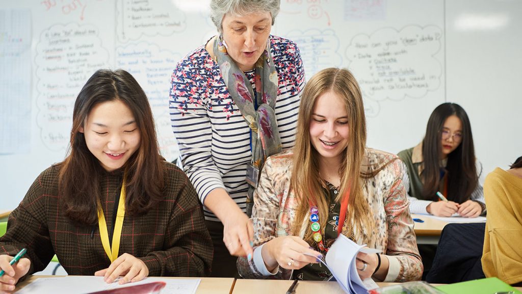 Female students and teacher in Abbey College Cambridge Maths class