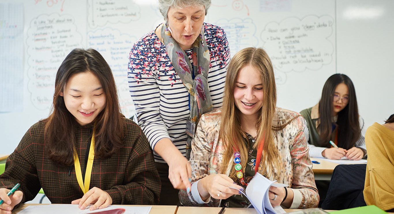 Female students and teacher in Abbey College Cambridge Maths class