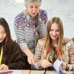 Female students and teacher in Abbey College Cambridge Maths class