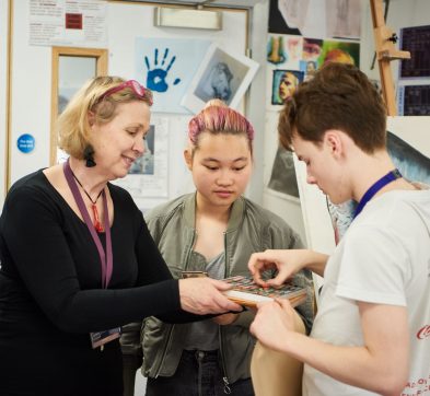 student picking up a pastel