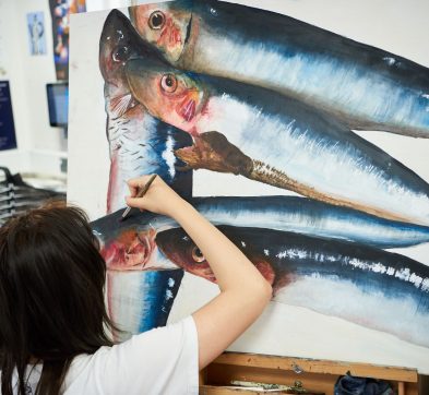 girl painting a fish