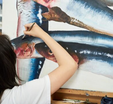 girl painting a fish