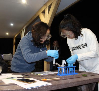 two girls setting up test tubes