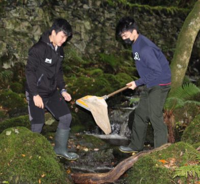 students collecting debris from a river