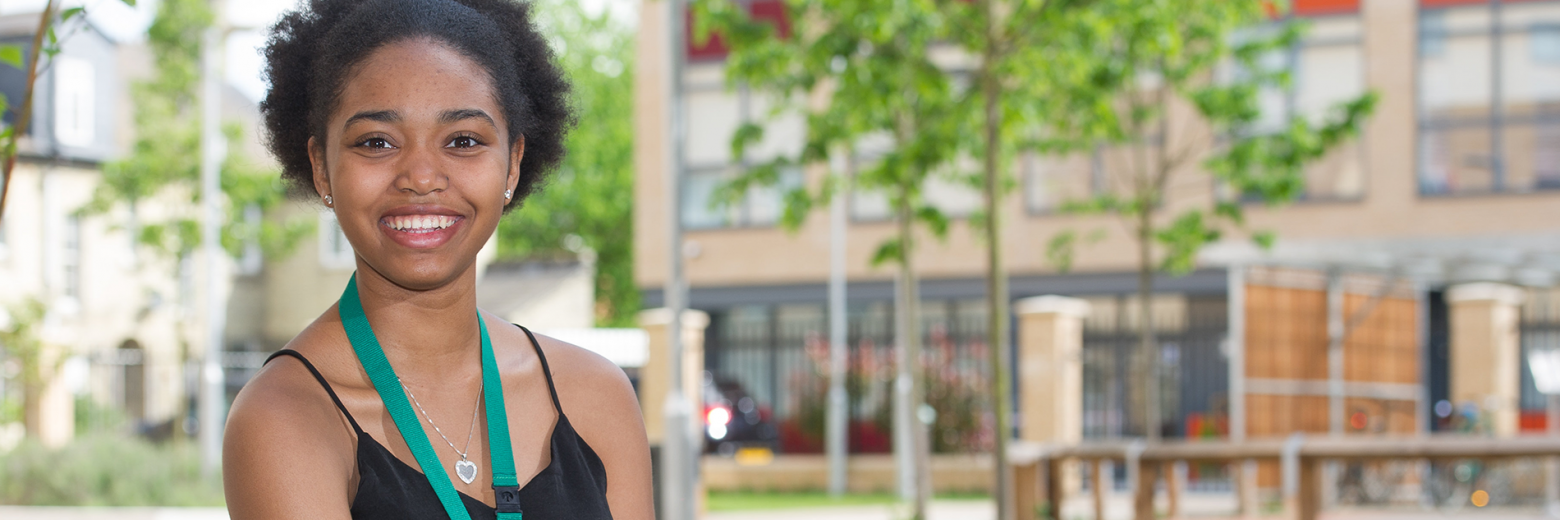 Nigerian Female Student Sitting In Abbey College Cambridge Courtyard