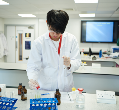 Abbey College Cambridge Student In Chemistry Laboratory