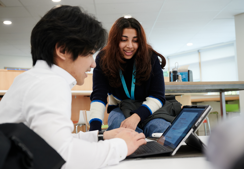 Students Working Together In The College Library