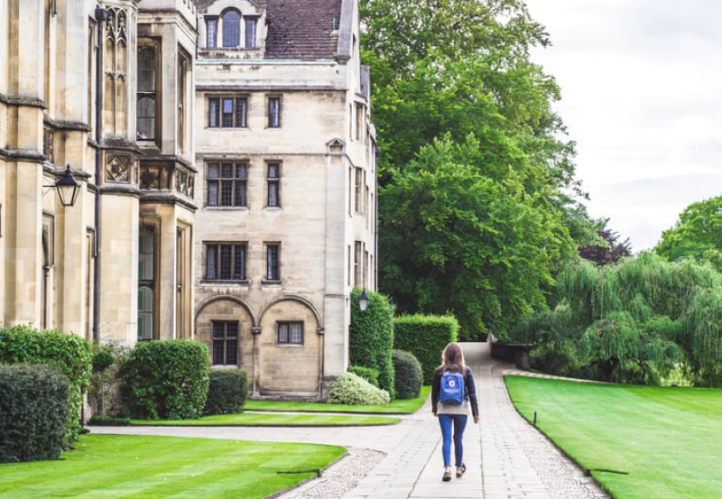 Student Walking In Front Of Oxbridge College Building