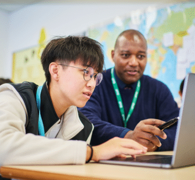 Student And Teacher In Business Class At Abbey College Cambridge