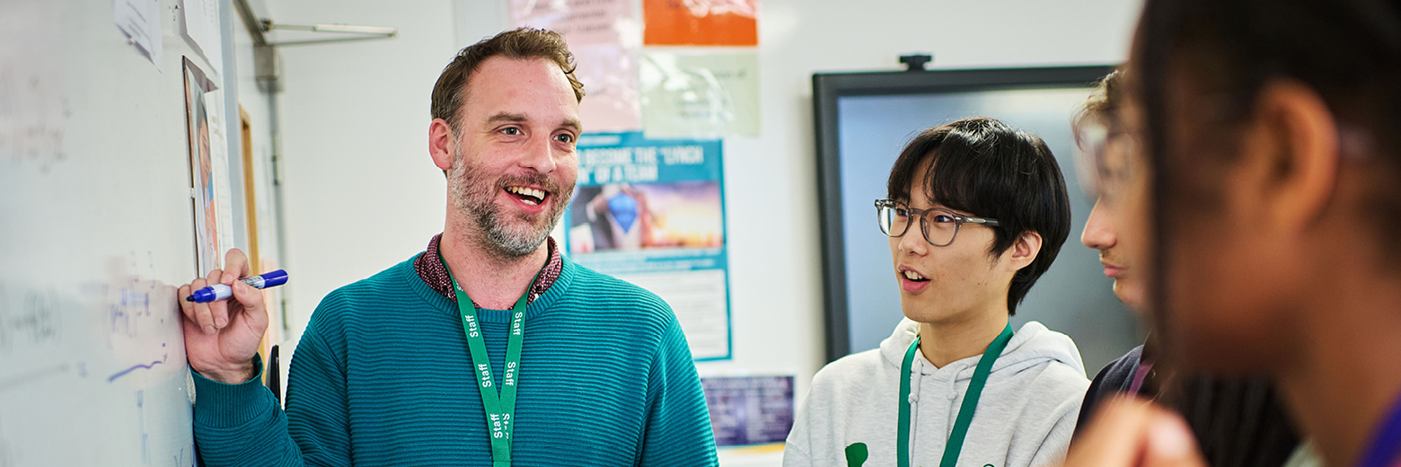 Students And Teacher Using The Writing Walls In Maths Class