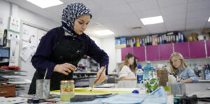 Female Student Working In Art Class At Abbey College Cambridge