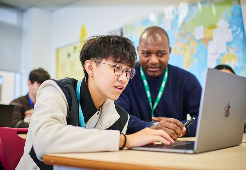 Student And Teacher In Business Class At Abbey College Cambridge